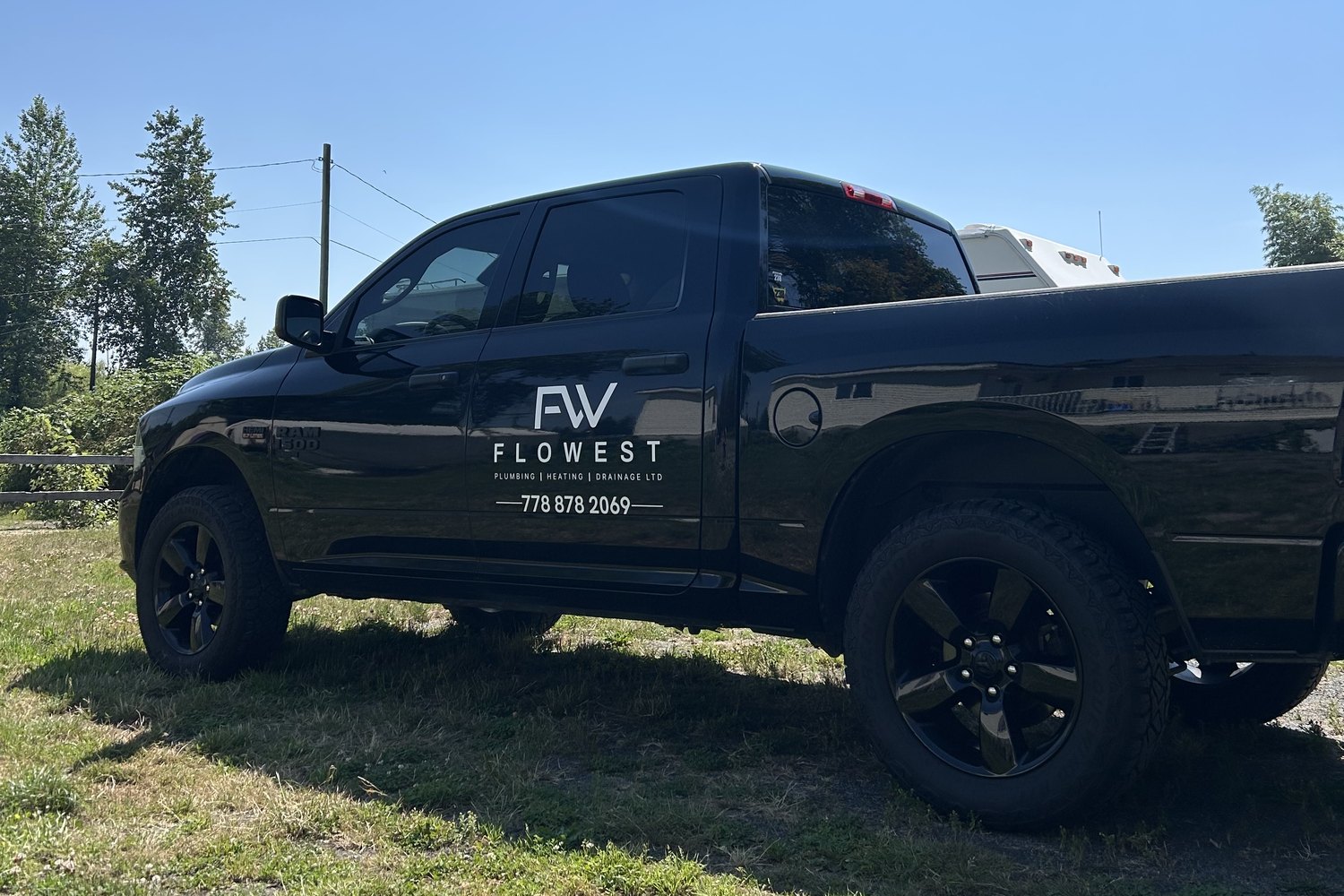 Flowest Plumbing service truck on a job site in Langley, BC
